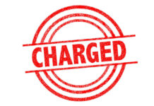 Officer’s Ambush Story Flips — Faces Assault Charges! Red charged stamp with circular border