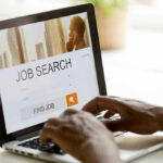 Person searching for jobs on a laptop.