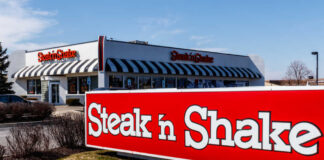 Exterior view of a Steak 'n Shake restaurant with a striped awning
