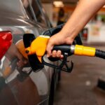 A person refueling a car at a gas station