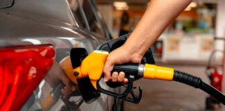 A person refueling a car at a gas station