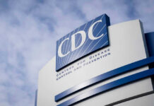 Ebola Panic Jumps Borders — Then Reality Hits CDC building sign against a cloudy sky.