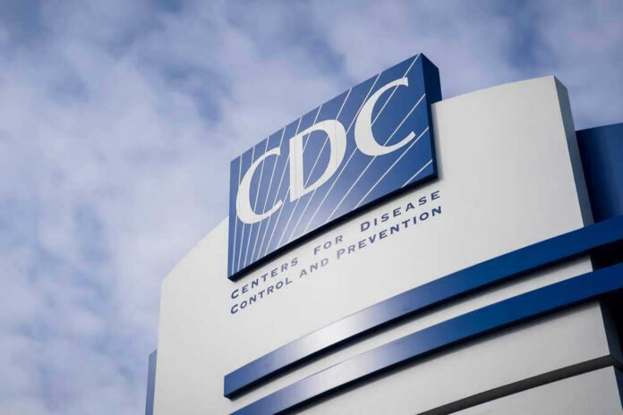 shutterstock_2123545061 CDC building sign against a cloudy sky.