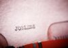 Close-up of a typewriter with the word 'JOBLESS' typed on paper