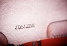 Tech Bloodbath Blamed On THIS! Close-up of a typewriter with the word 'JOBLESS' typed on paper