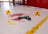 McDonald’s Ambush BLOODBATH Stuns Neighborhood Handgun on a blood-stained floor with evidence markers in a locker room