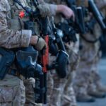 Law enforcement officers in tactical gear holding weapons