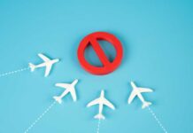 One Word Forces Transatlantic Flight Back To U.S. A red prohibition sign surrounded by white airplane models on a blue background