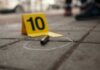 Chicago War Zone: 12 Shot As Drive-By Erupts Bullet casing on the ground next to a numbered evidence marker