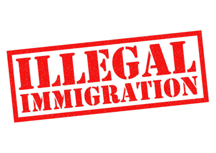 shutterstock_368718257 Red illegal immigration stamp on white background