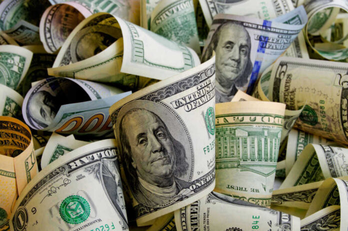 shutterstock_518001346 Rolled U.S. dollar bills in various denominations.