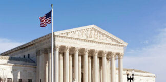 U.S. Supreme Court building with American flag.
