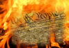 Burning U.S. Constitution amidst flames.