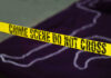 4th of July Horror: Kids Shot At Barbecue Yellow crime scene tape marking off an area with a chalk outline