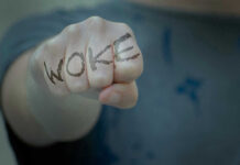 Woke Makeover Backfires — CEO Out Fist with Woke written on fingers.
