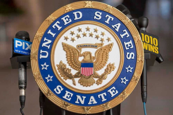 shutterstock_2130082274 United States Senate seal with microphones in front.