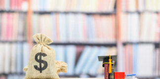 Money bag and books balanced on a seesaw.