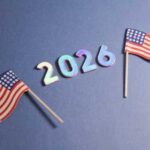 Two small American flags next to the numbers 2026 on a blue background