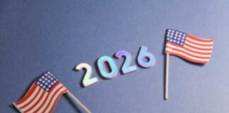 Two small American flags next to the numbers 2026 on a blue background