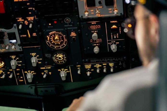 Airplane,Cabin,The,Pilot,Checks,The,Plane's,Electronics,By,Pressing