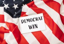 A notepad with the words 'DEMOCRAT WIN' placed on an American flag