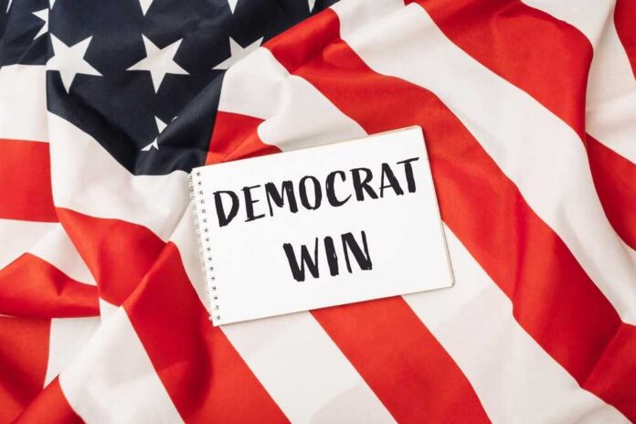 A notepad with the words 'DEMOCRAT WIN' placed on an American flag