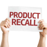 New Recall Sparks Choking Fears Hands holding a sign that reads 'PRODUCT RECALL'