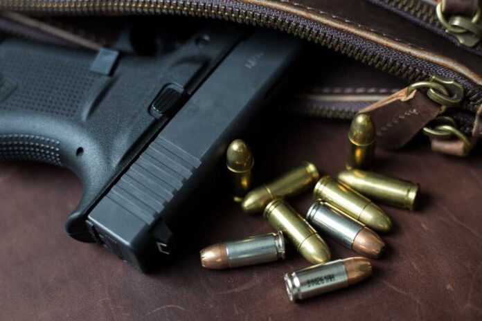 9mm,Sub,Compact,Everday,Carry,Modern,Gun,With,Bullet,On Handgun with loose ammunition beside a leather bag
