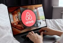 Airbnb’s July 4 Crackdown Sparks Fury Airbnb logo on a phone screen, near keyboard.