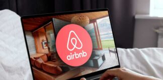 Airbnb logo on a phone screen, near keyboard.