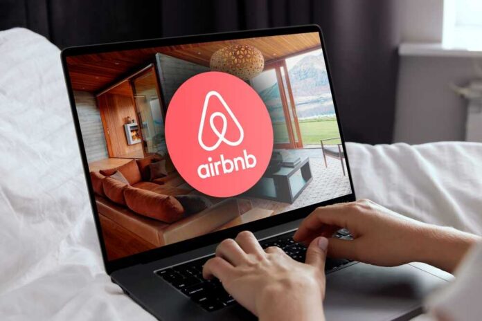 Airbnb logo on a phone screen, near keyboard.
