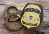 Wrong Man? ICE Raid Turns Deadly ICE officer badge next to handcuffs on a wooden surface