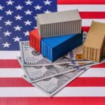 Mini shipping containers on US dollars over an American flag