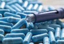 Insulin pen on blue capsules
