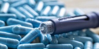 Insulin pen on blue capsules