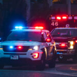 Family Dinner Turns Massacre Police car and ambulance with flashing lights nighttime