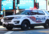 Police SUV with lights on in an urban environment