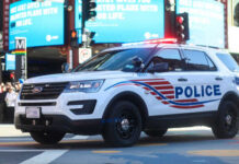 Police SUV with lights on in an urban environment