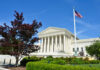 United States Supreme Court building with columns and an American flag