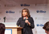A woman speaking at a podium during an awards gala
