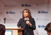 A woman speaking at a podium during an awards gala