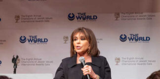 A woman speaking at a podium during an awards gala
