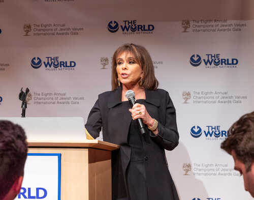 A woman speaking at a podium during an awards gala