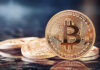 Bitcoin Vaults Gutted in 41 Minutes Bitcoin coins on a reflective surface.