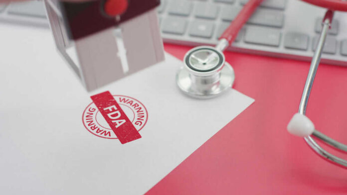 shutterstock_1795453510 FDA warning stamp near stethoscope and keyboard