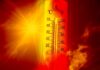 Thermometer displaying high temperature against a sunset background