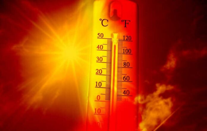 Thermometer displaying high temperature against a sunset background