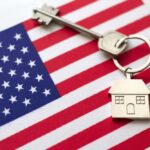 Housing Crisis Shoves Millions Back Home House key with keychain on American flag