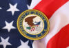 Department of Justice seal on American flag.