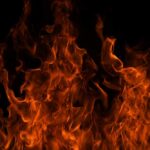 Firefight Turns Fatal Mid-Air Close-up of vibrant flames against a black background